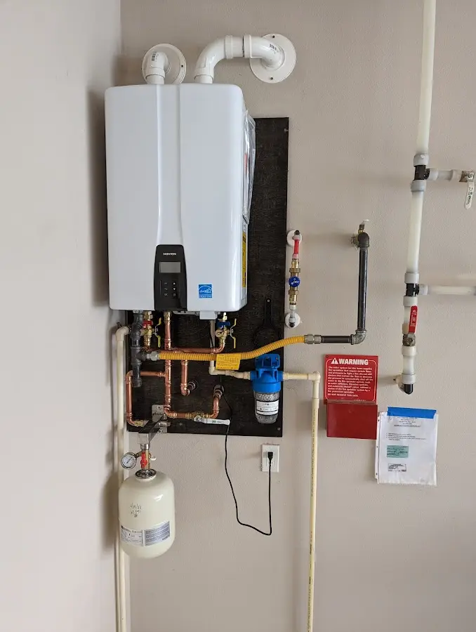 Professional plumber installing copper piping in a Bentonville home